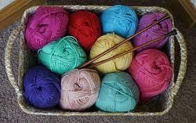 Basket of yarn balls and knitting needles